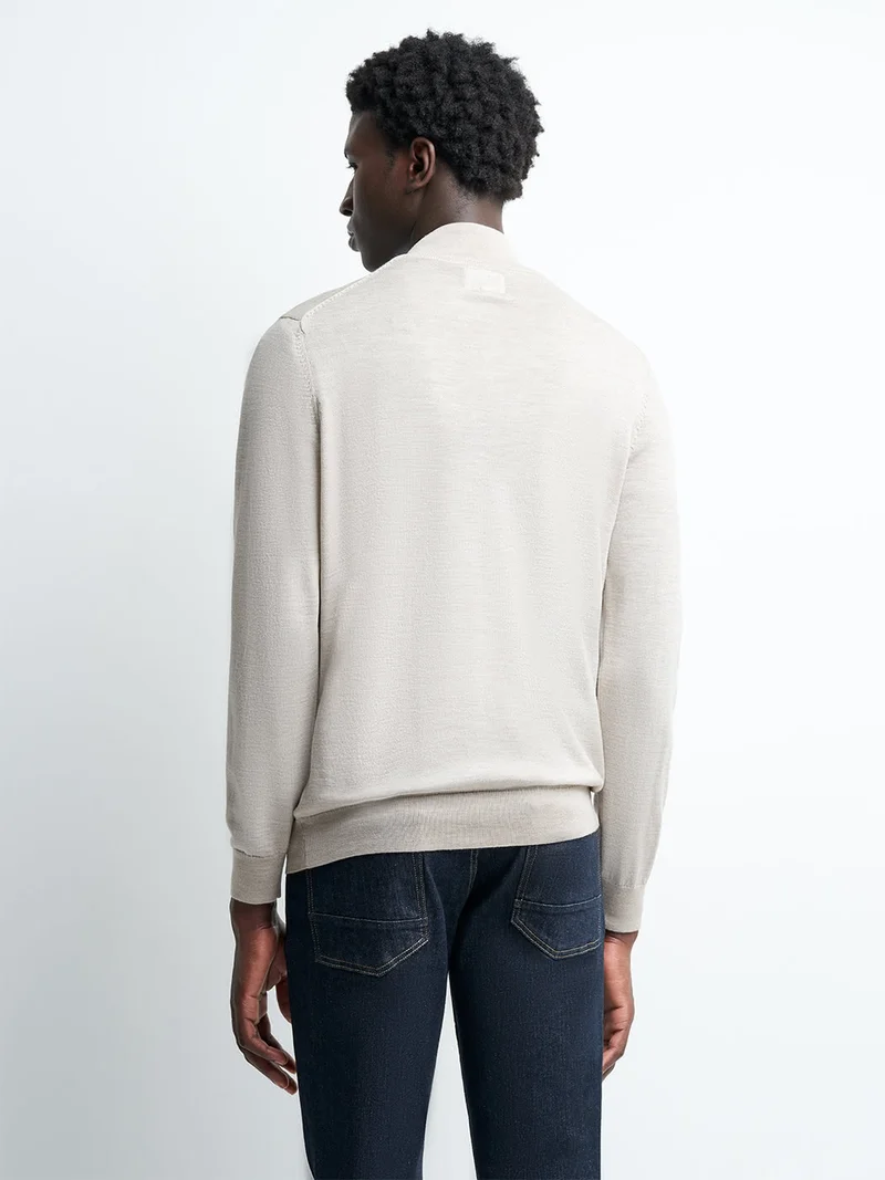 Pull col montant zippé en laine mérinos