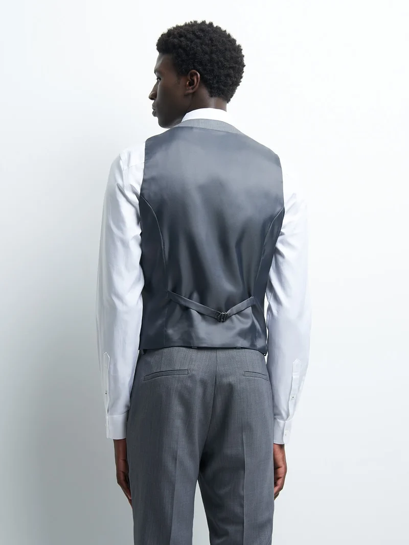 Gilet coordonnable en laine faux uni