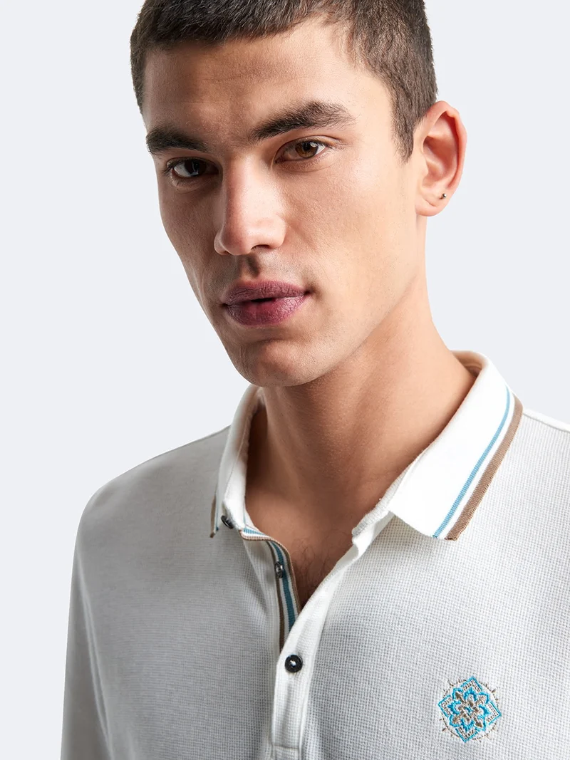 Polo manches longues en coton brodé